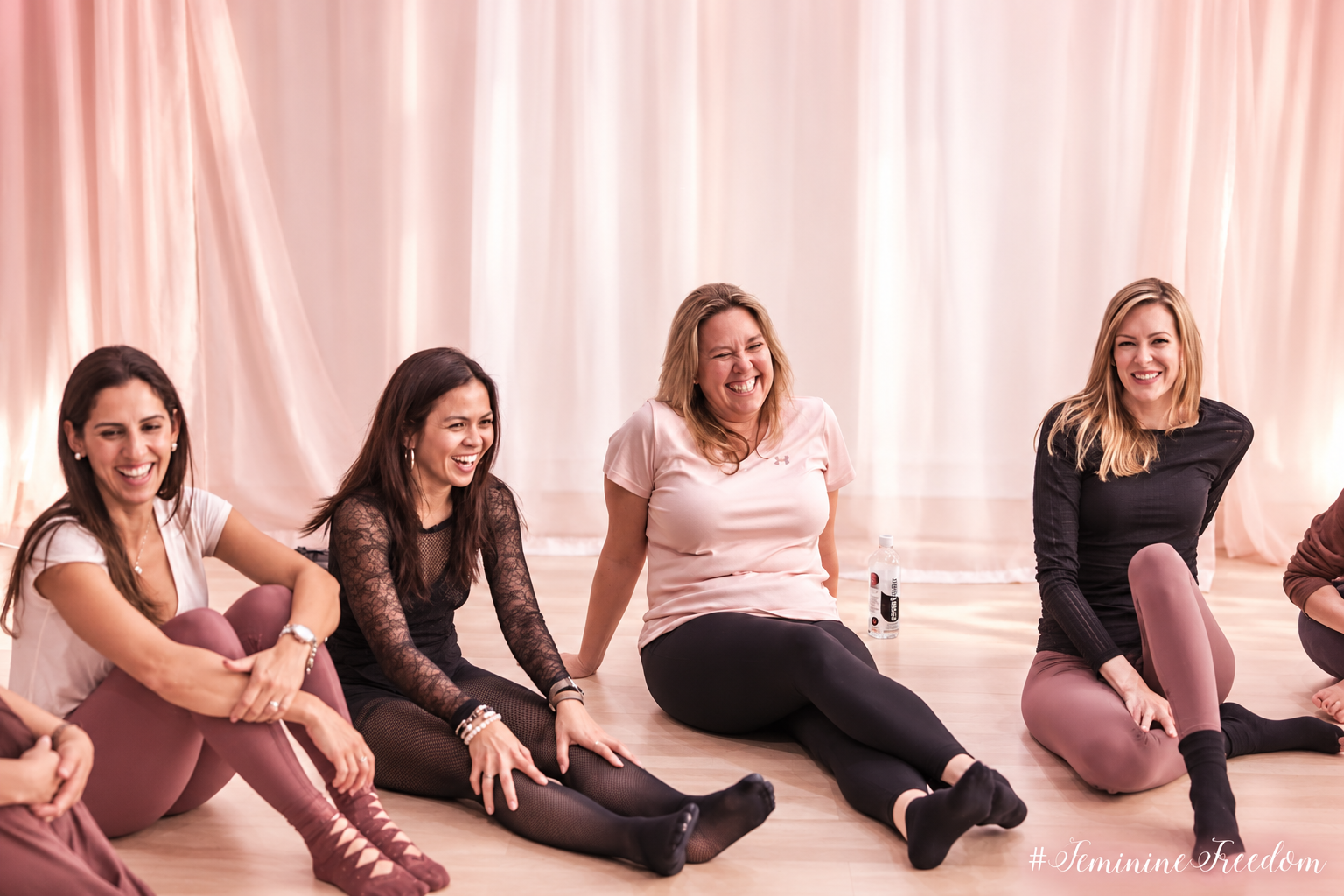 Women laughing together in a joyful circle